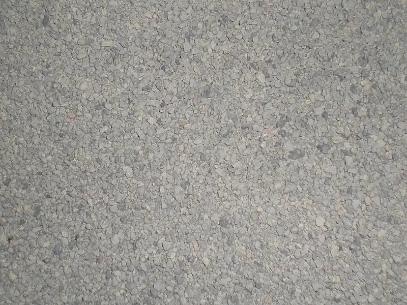 Close up of fresh fine grey granular clay cat litter filling the frame