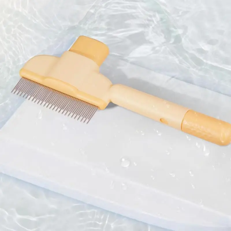 Orange self-cleaning pet comb with metal teeth on a white surface